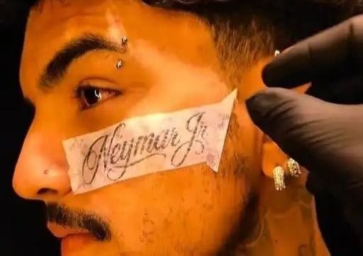 Jovem com o nome de Neymar tatuado no rosto após convocação.