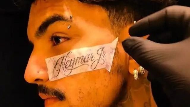 Jovem com o nome de Neymar tatuado no rosto após convocação.